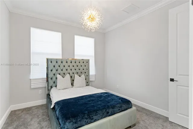 a bedroom with a bed and a chandelier fan