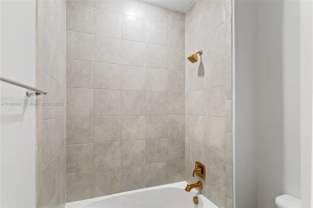 a bathroom with a sink a large mirror and a bathtub