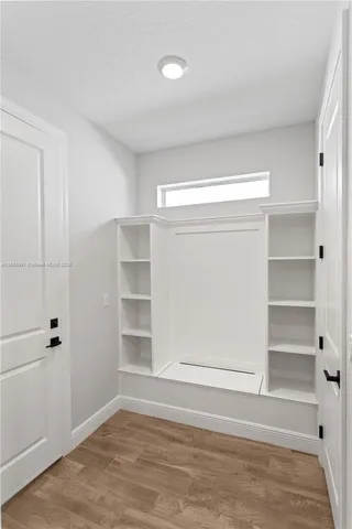 a kitchen with stainless steel appliances granite countertop a sink and cabinets with wooden floor