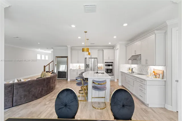a kitchen with a dining table chairs and a refrigerator