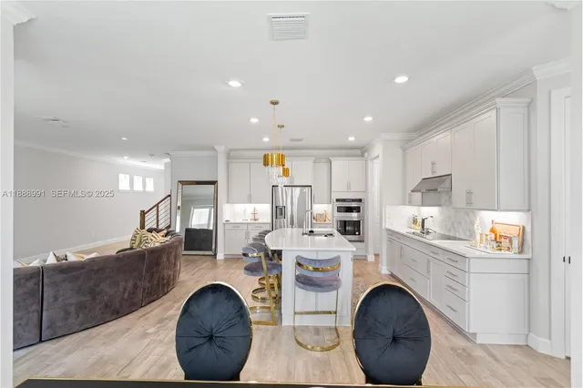 a kitchen with a dining table chairs and a refrigerator