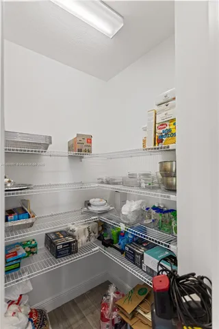 an empty room with wooden floor and door