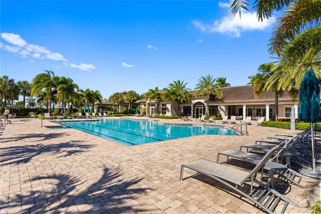 a swimming pool with outdoor seating and yard