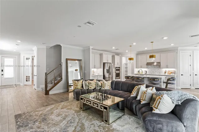 a living room with furniture and kitchen view