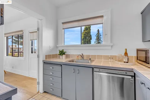 a kitchen with a sink stove and cabinets