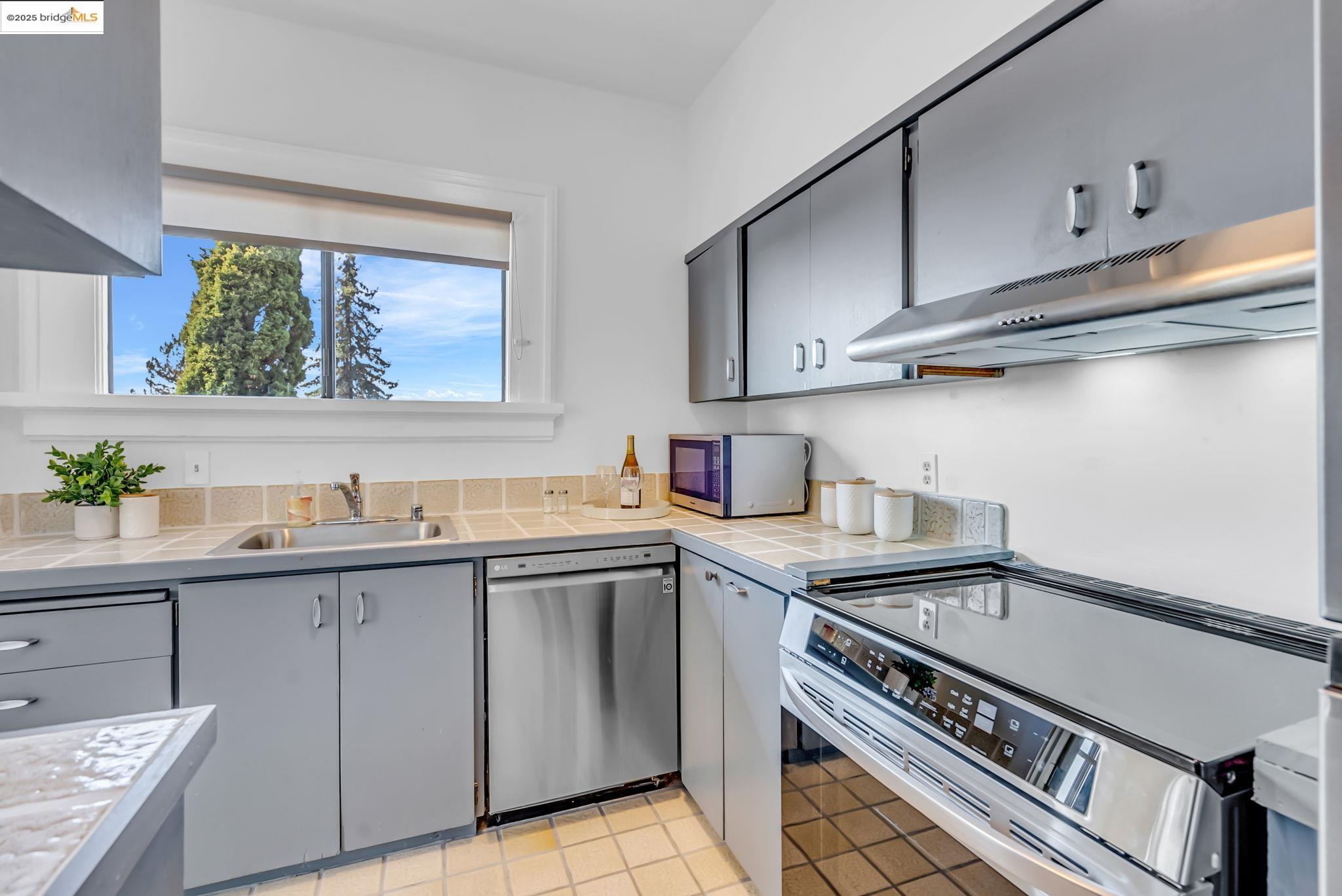 2907 Channing Way Berkeley, CA 94704 - Photo 19 of 26 a kitchen with a sink stove and cabinets