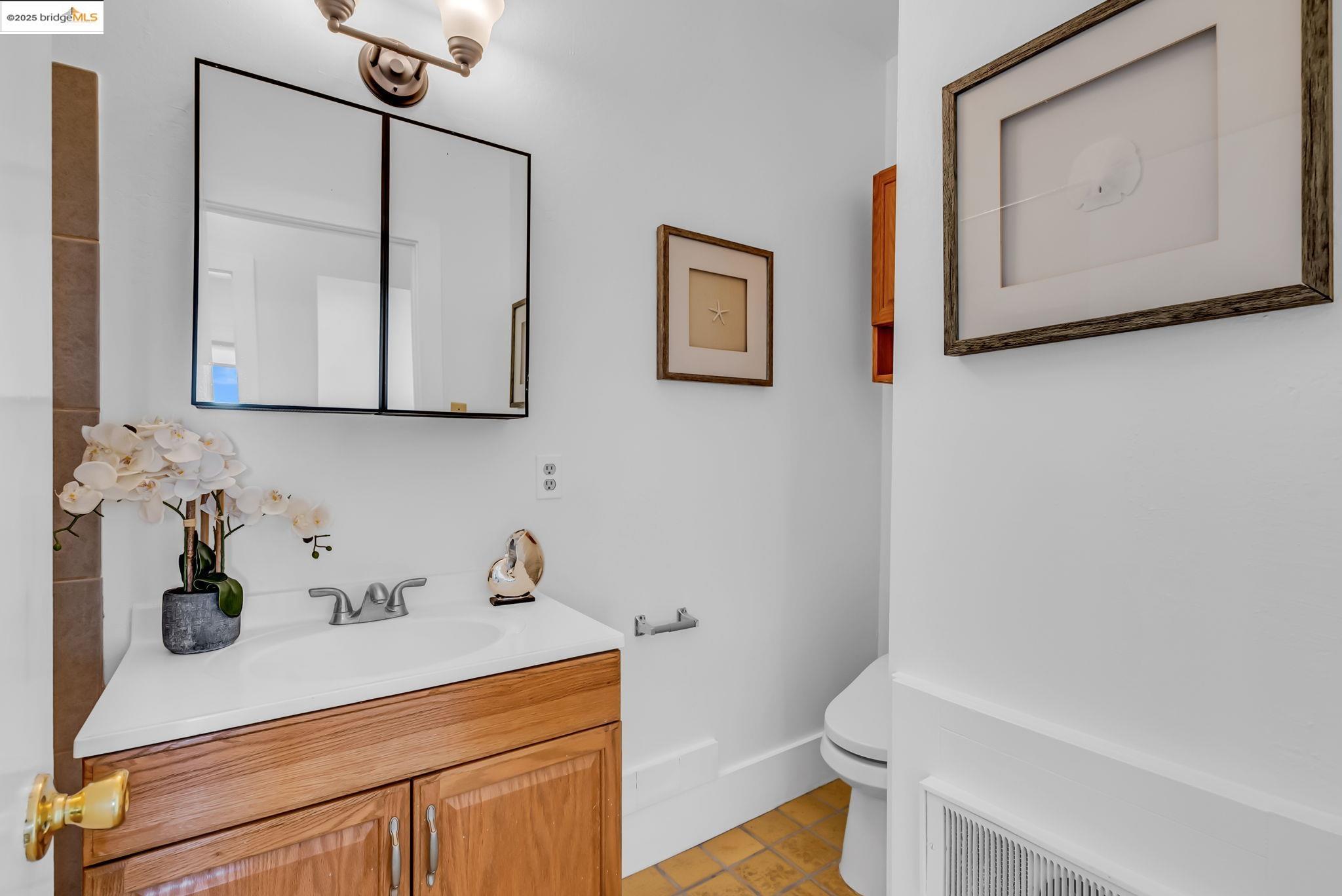 2907 Channing Way Berkeley, CA 94704 - Photo 20 of 26 a bathroom with a sink a toilet and mirror