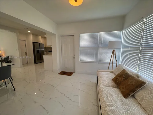 a front view of a house with a yard and tree