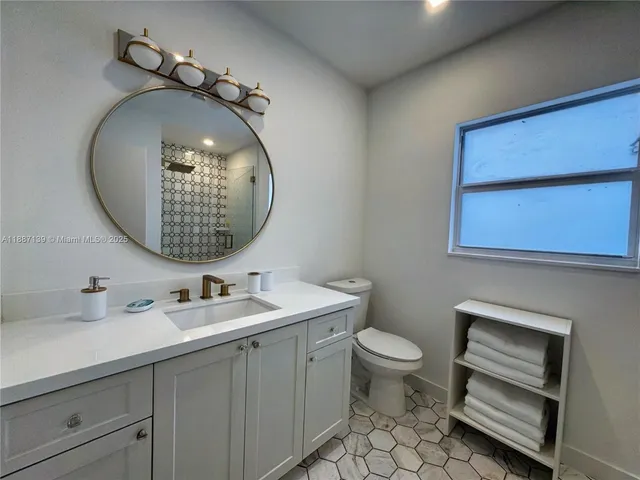 a kitchen with a refrigerator sink and cabinets