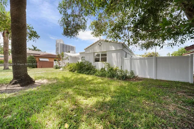 a living room with furniture a large window and a table