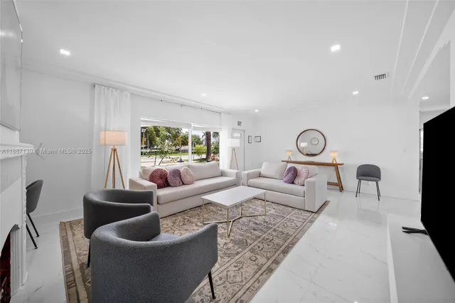 a living room with furniture and a large mirror