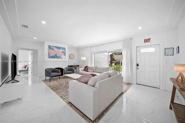 a living room with furniture a bed and a wall painting