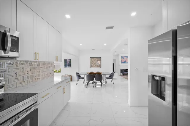 a bedroom with a bed and painting on the wall