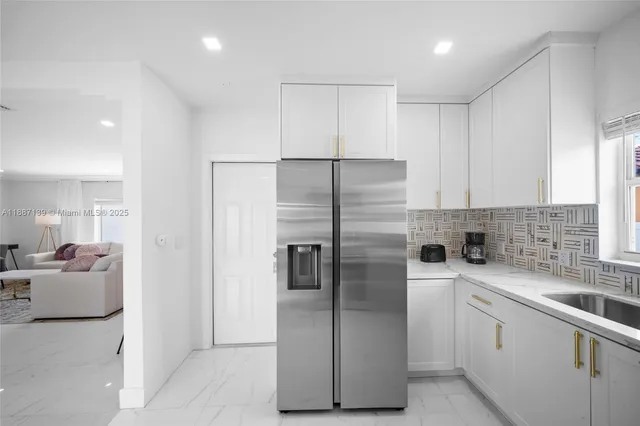a view of a hallway with furniture and a potted plant