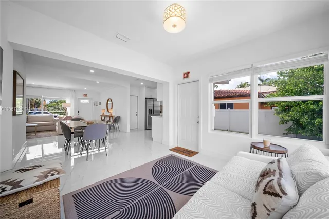 a view of a chair and table in backyard of the house