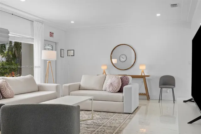 a view of a house with a yard and potted plants
