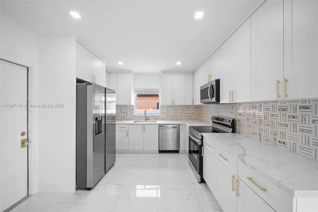 a living room with furniture a flat screen tv a rug and a large window