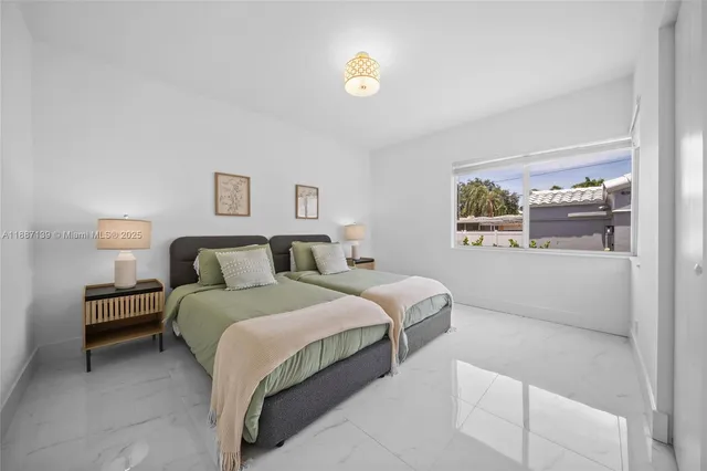 a living room with furniture a flat screen tv and a window