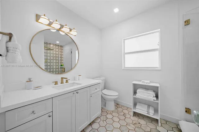 a bedroom with a bed and a night stand next to a window