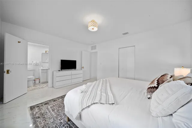 a bedroom with a bed and a night stand