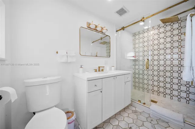 a living room with furniture a rug and a flat screen tv