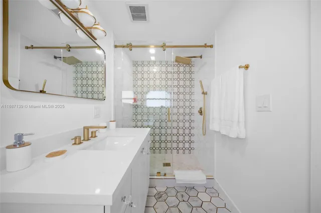 a bedroom with two beds and a lamp