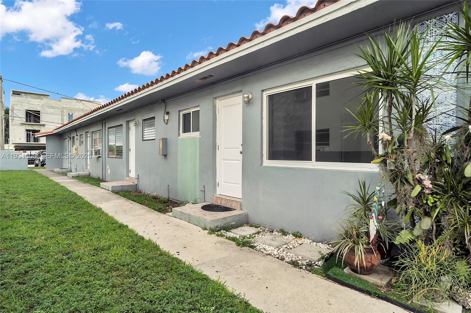634 Southwest 10th Street, Unit 4 Miami, FL 33130 - Photo 2 of 19 a front view of a house with a garden