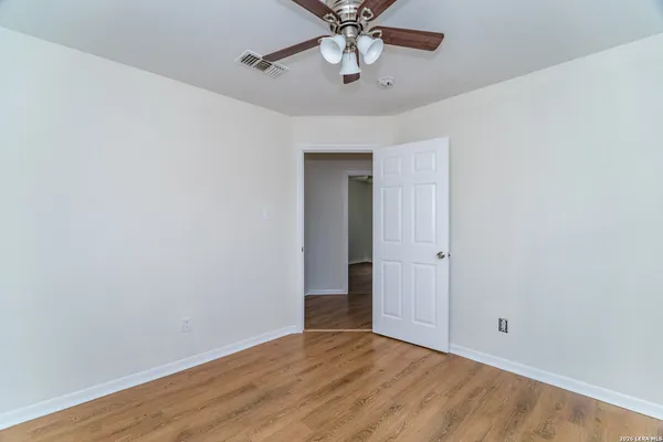 a view of an empty room with a fan