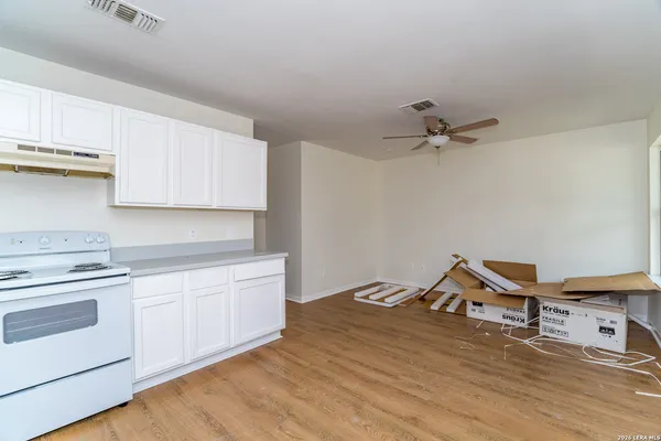 a view of a kitchen with a sink cabinets and wooden floor