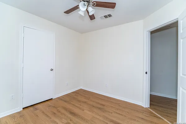 a view of a room with wooden floor