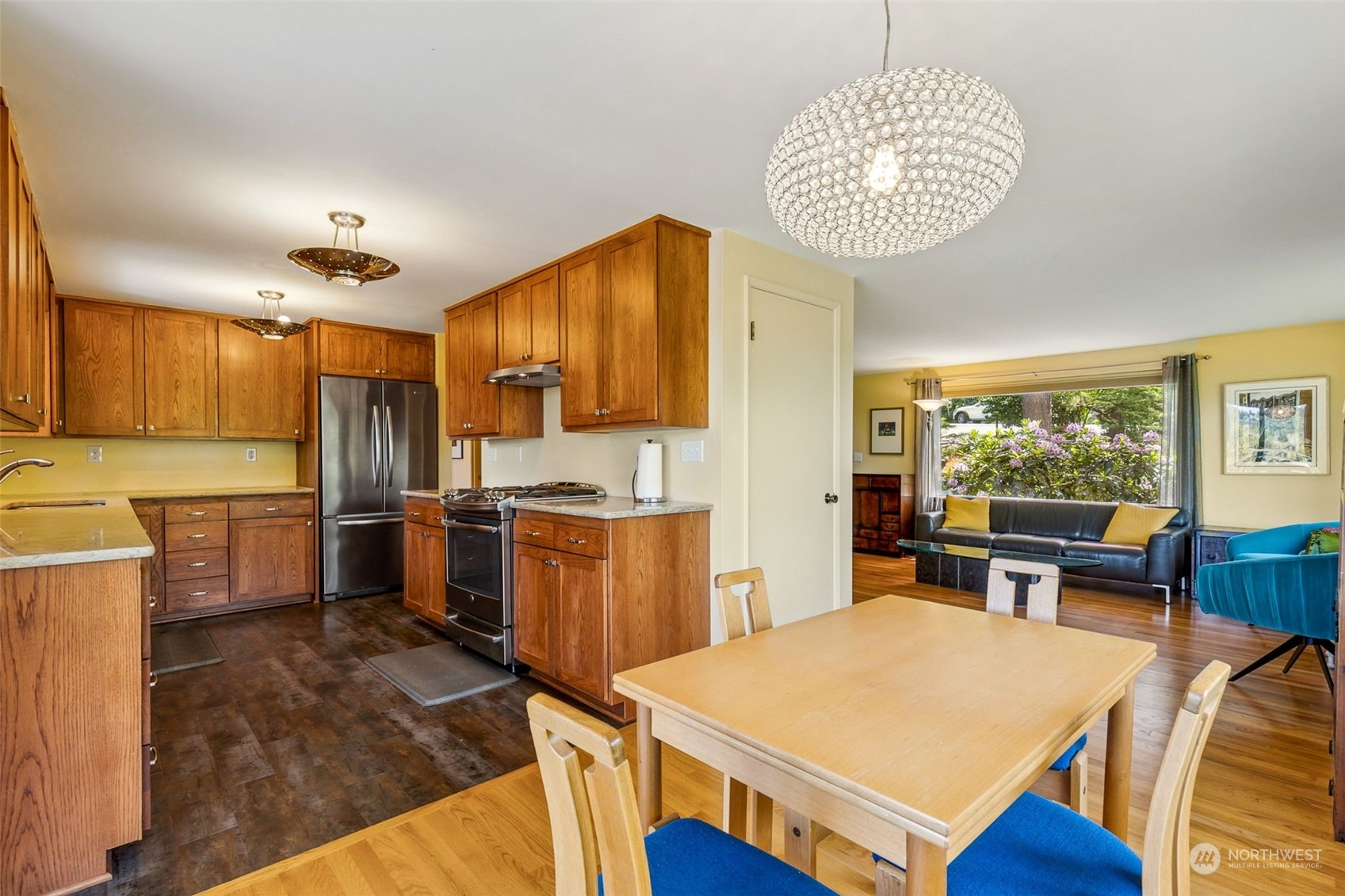 424 Southwest Normandy Road Normandy Park, WA 98166 - Photo 7 of 23 a kitchen that has a table chairs and wooden cabinets