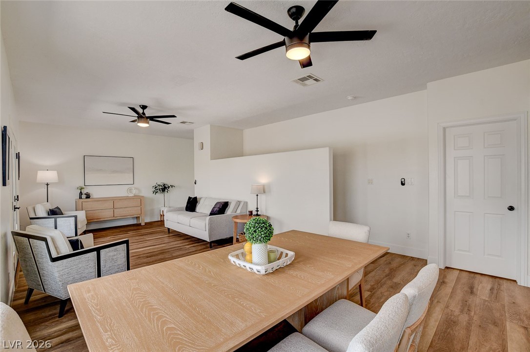 4362 Thistle Street Logandale, NV 89021 - Photo 15 of 99 An inviting open-concept living area with abundant natural light and wood-style LVP flooring.