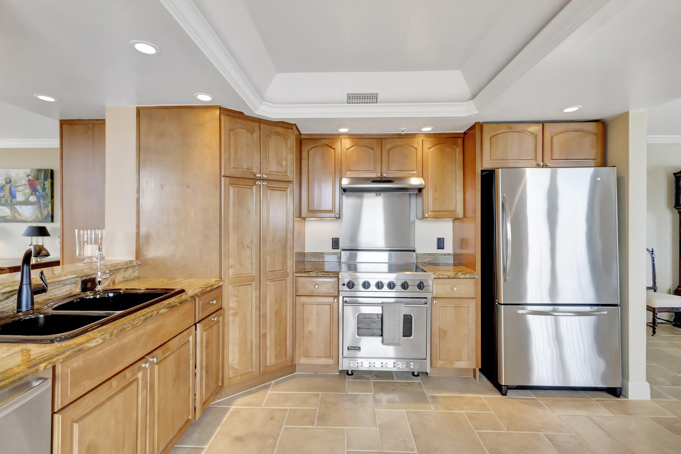 400 South Beach Road, Unit 804 Tequesta, FL 33469 - Photo 15 of 65 a kitchen with stainless steel appliances a refrigerator and a stove top oven