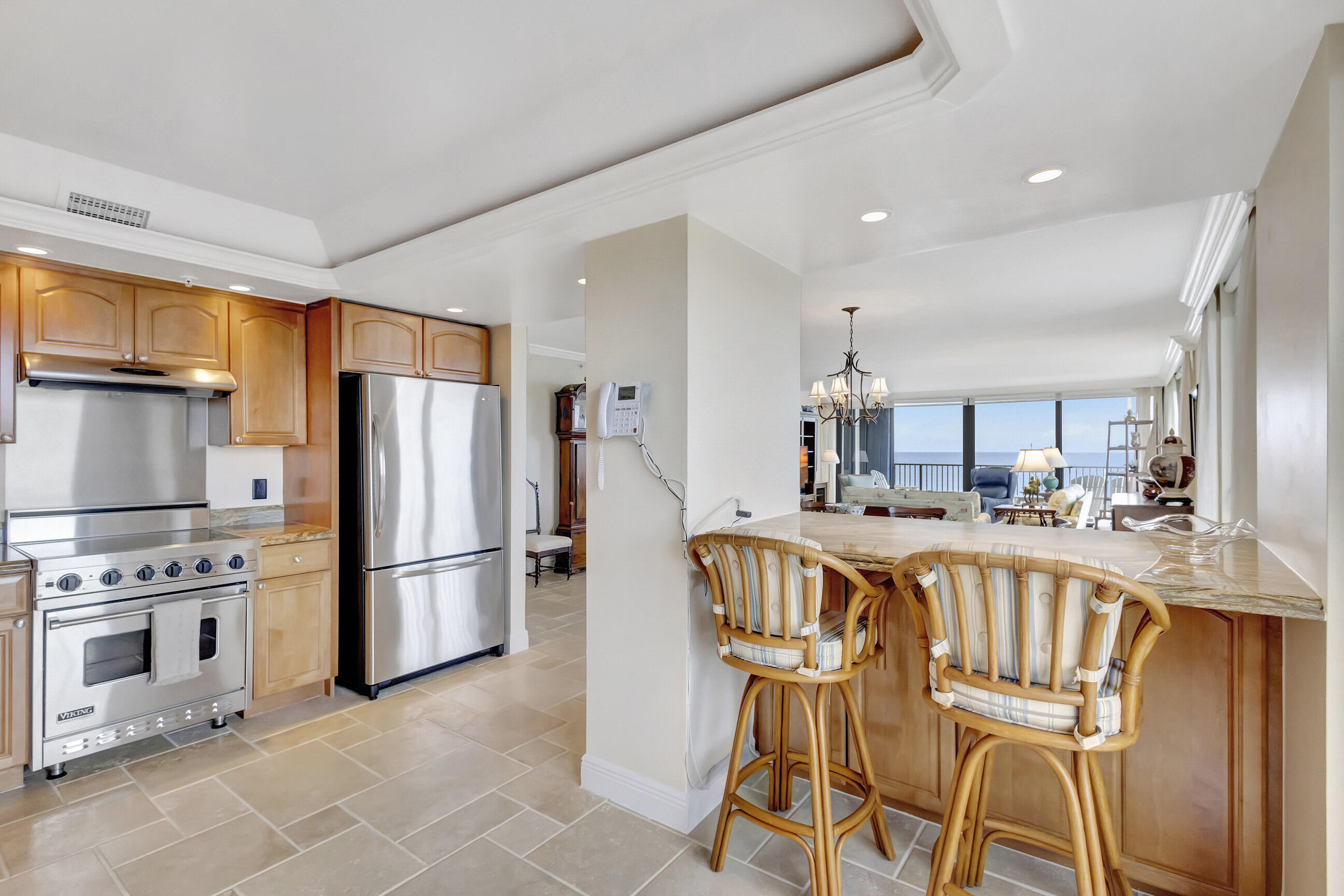 400 South Beach Road, Unit 804 Tequesta, FL 33469 - Photo 16 of 65 a kitchen with a table chairs refrigerator and microwave