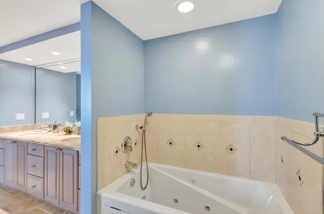 a bedroom with two beds and a large mirror