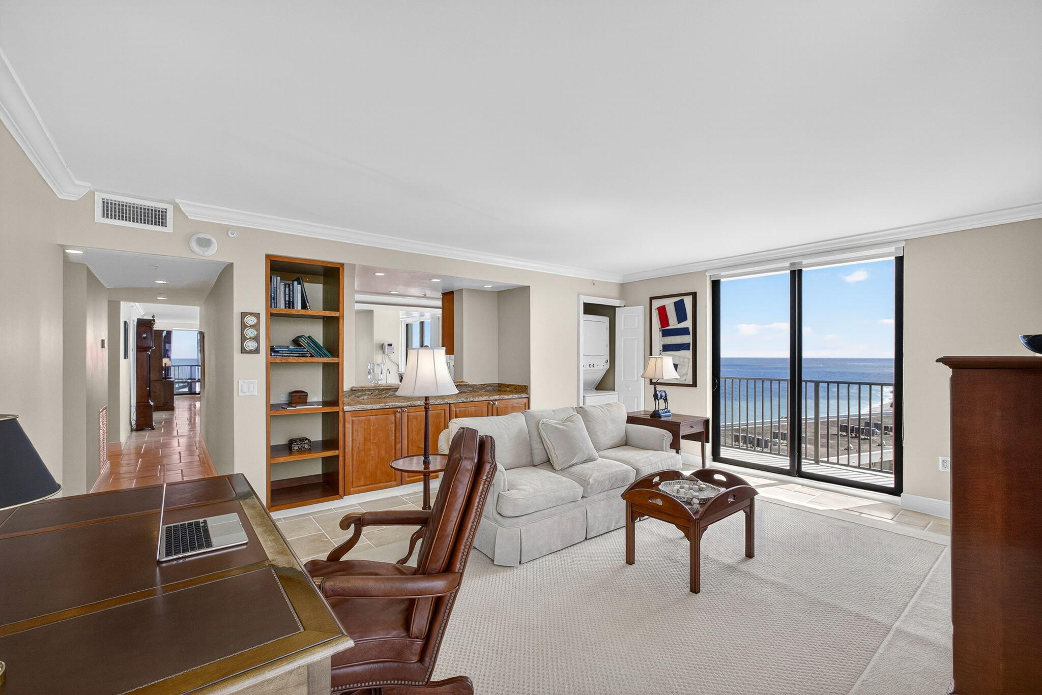 400 South Beach Road, Unit 804 Tequesta, FL 33469 - Photo 38 of 65 a living room with furniture a bookshelf and a large window