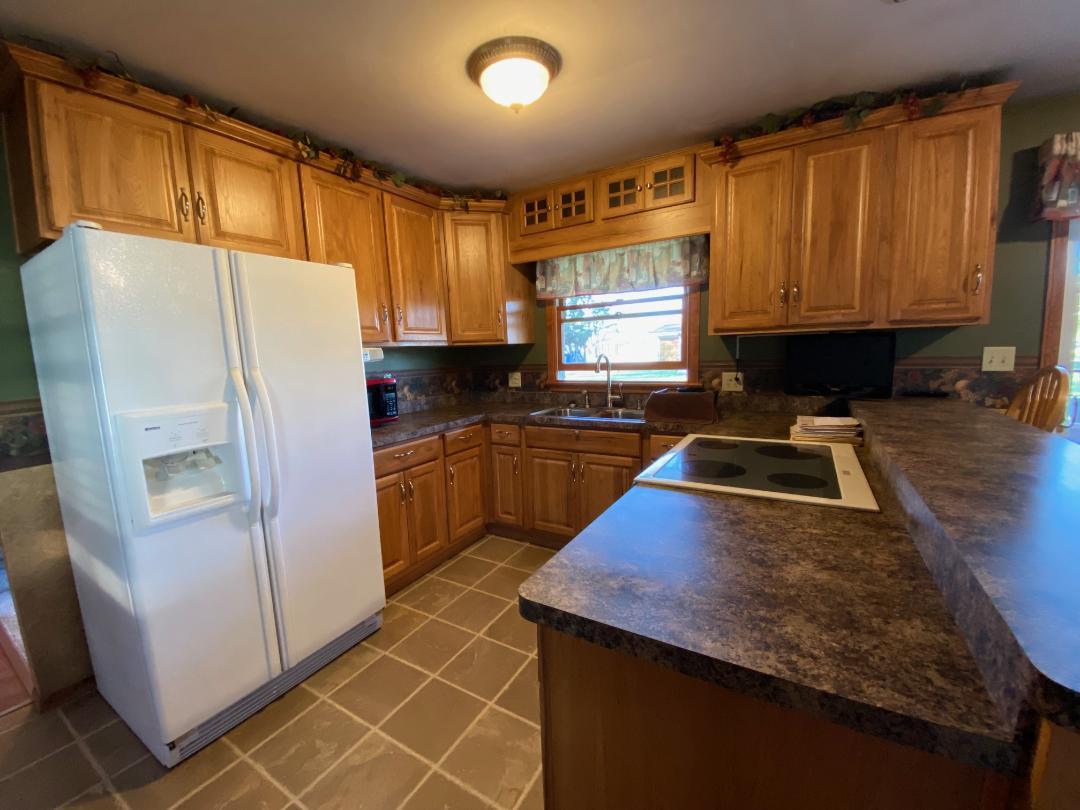 306 Andrew Street Dwight, IL 60420 - Photo 6 of 25 a kitchen with a sink a counter top space cabinets and stainless steel appliances
