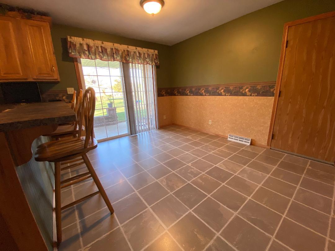 306 Andrew Street Dwight, IL 60420 - Photo 7 of 25 an empty room with wooden floor and windows
