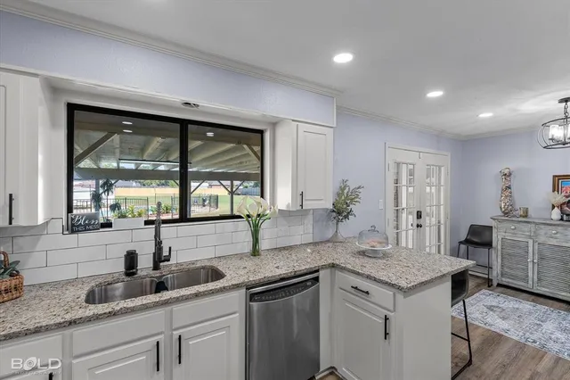 a kitchen with a sink and large window