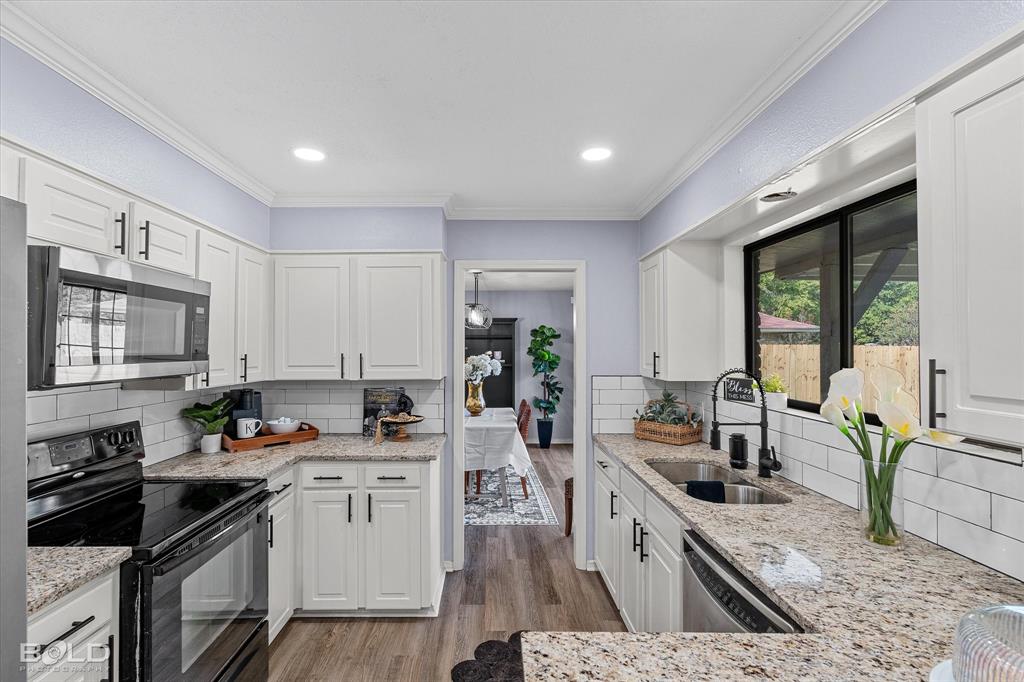 5505 Hickory Ridge Drive Bossier City, LA 71111 - Photo 14 of 36 a kitchen that has a lot of cabinets in it wooden floor and a sink
