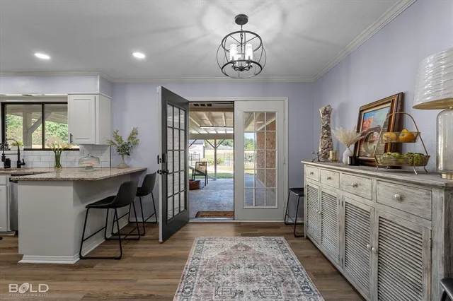 a kitchen with stainless steel appliances granite countertop a sink and dishwasher a oven with white cabinets