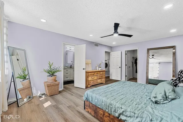 a bedroom with a large bed and a dresser