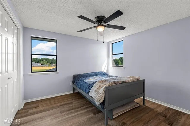 a bed sitting in a bedroom next to a window