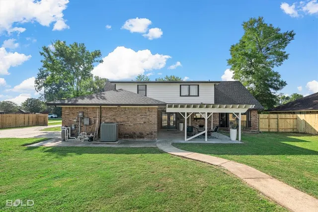a view of a house with a yard and sitting area