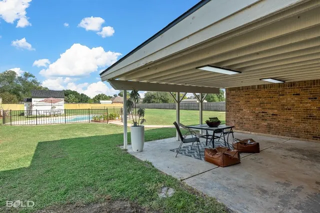 a view of a backyard with sitting area