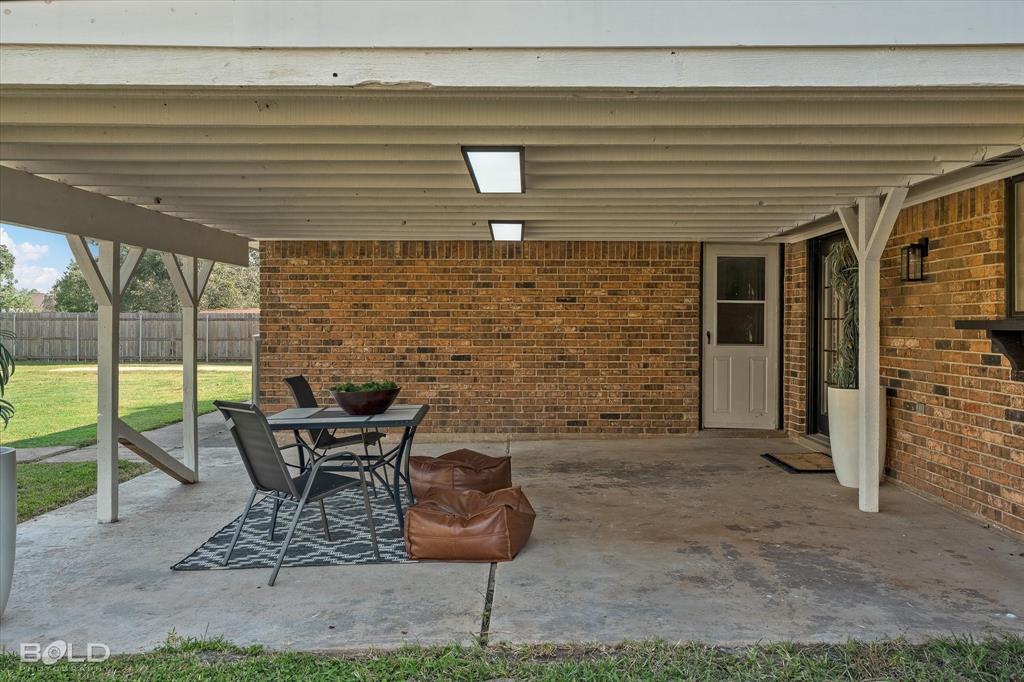 5505 Hickory Ridge Drive Bossier City, LA 71111 - Photo 36 of 36 a view of a patio with table and chairs and wooden floor