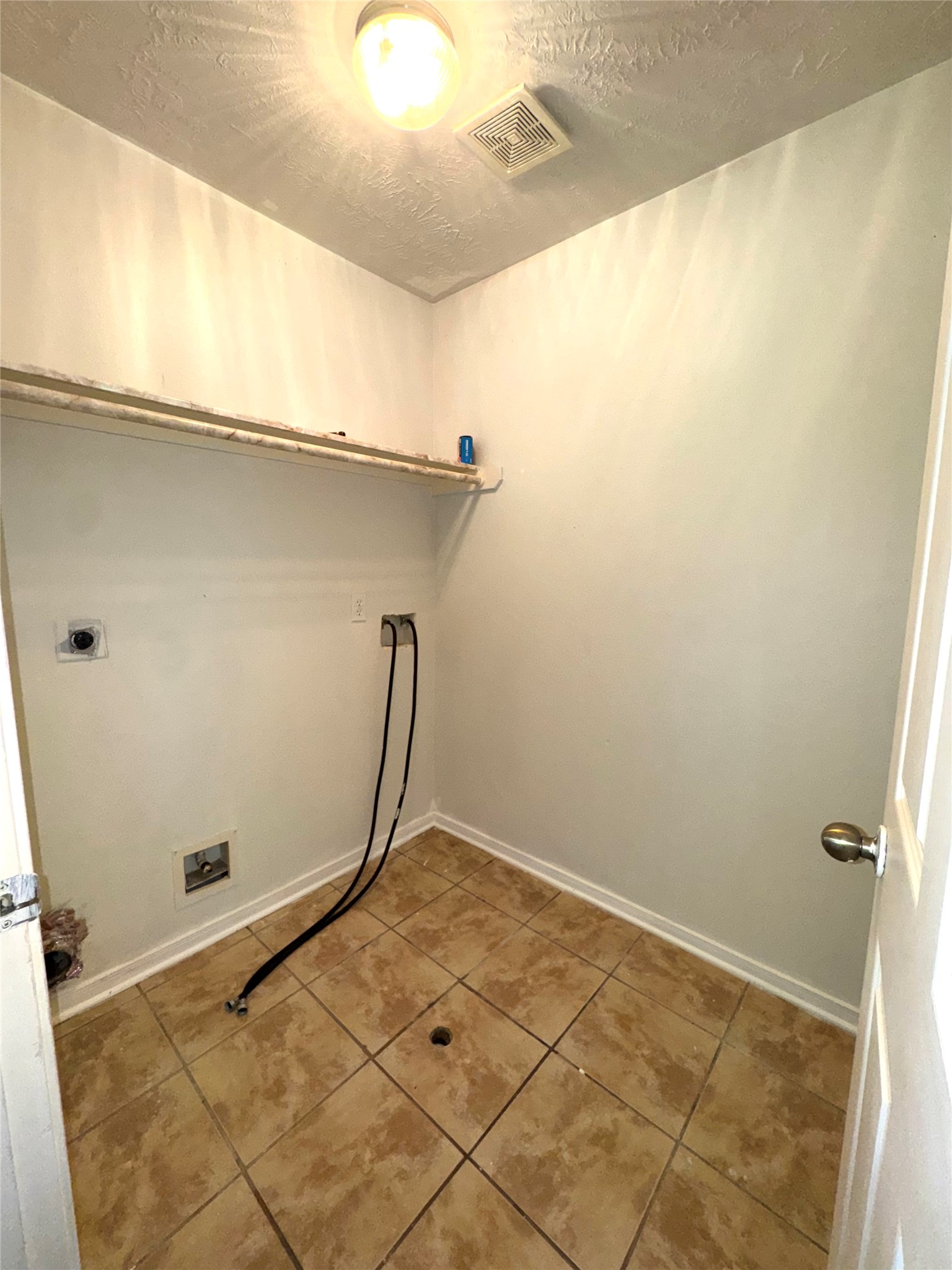 15931 Winston Point Lane Houston, TX 77084 - Photo 14 of 30 a view of a room with rack on the wall and a potted plant