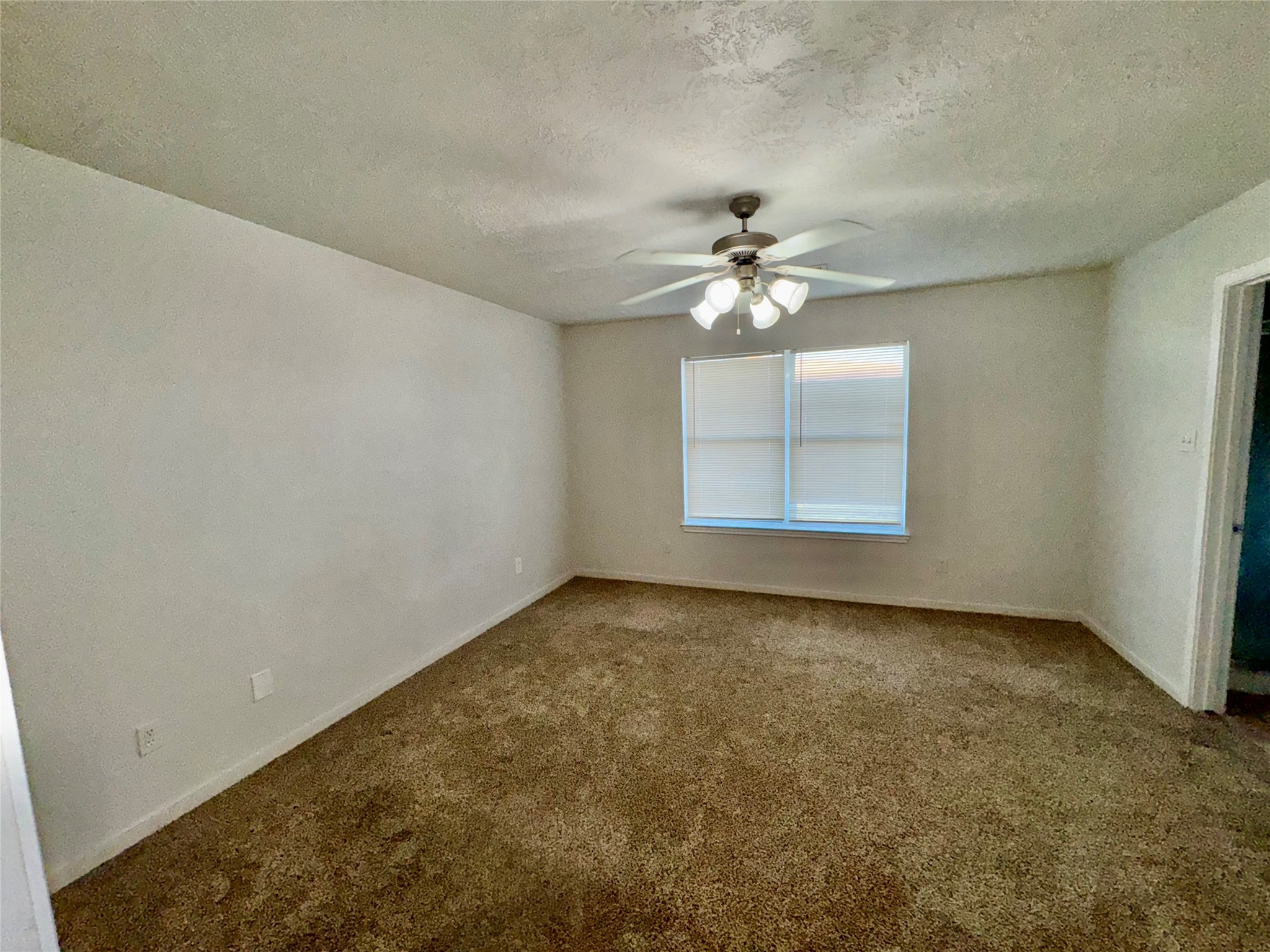15931 Winston Point Lane Houston, TX 77084 - Photo 15 of 30 an empty room with windows and chandelier fan