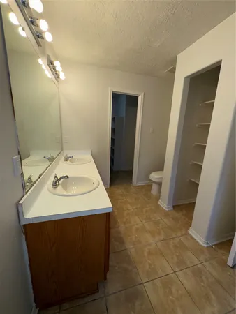 a bathroom with a sink a toilet and vanity
