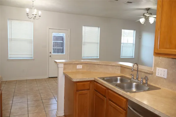 a kitchen with a sink cabinets and window